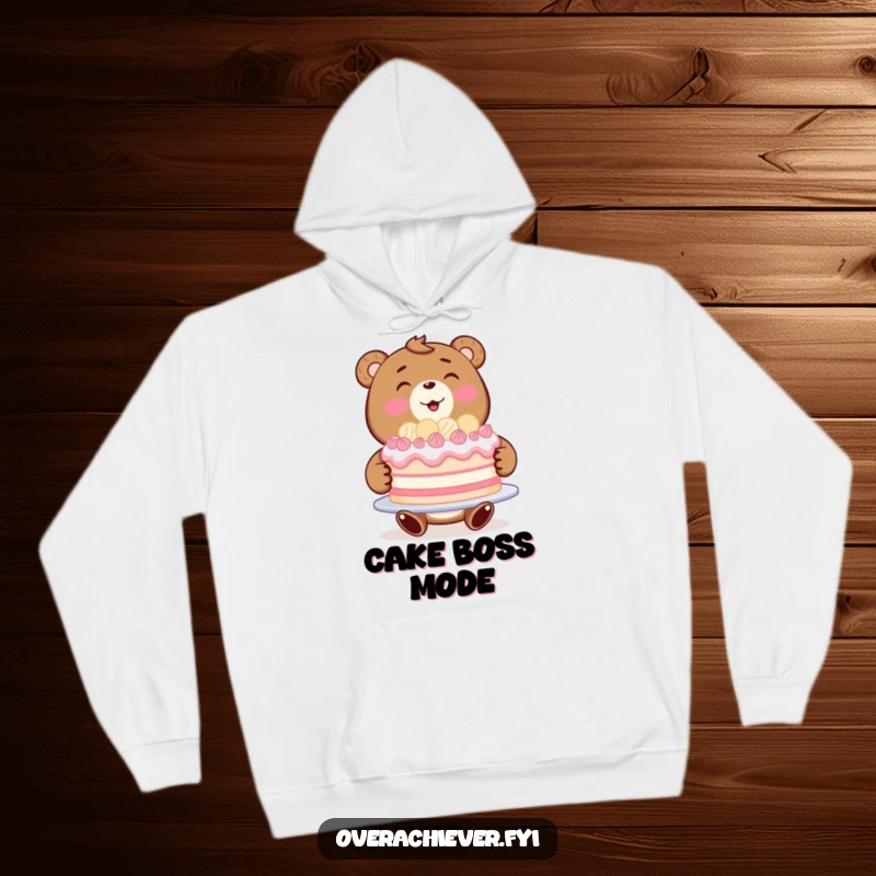 Funny bear baker hoodie showing a happy bear beaming with pride while presenting a magnificent, flawless cake.