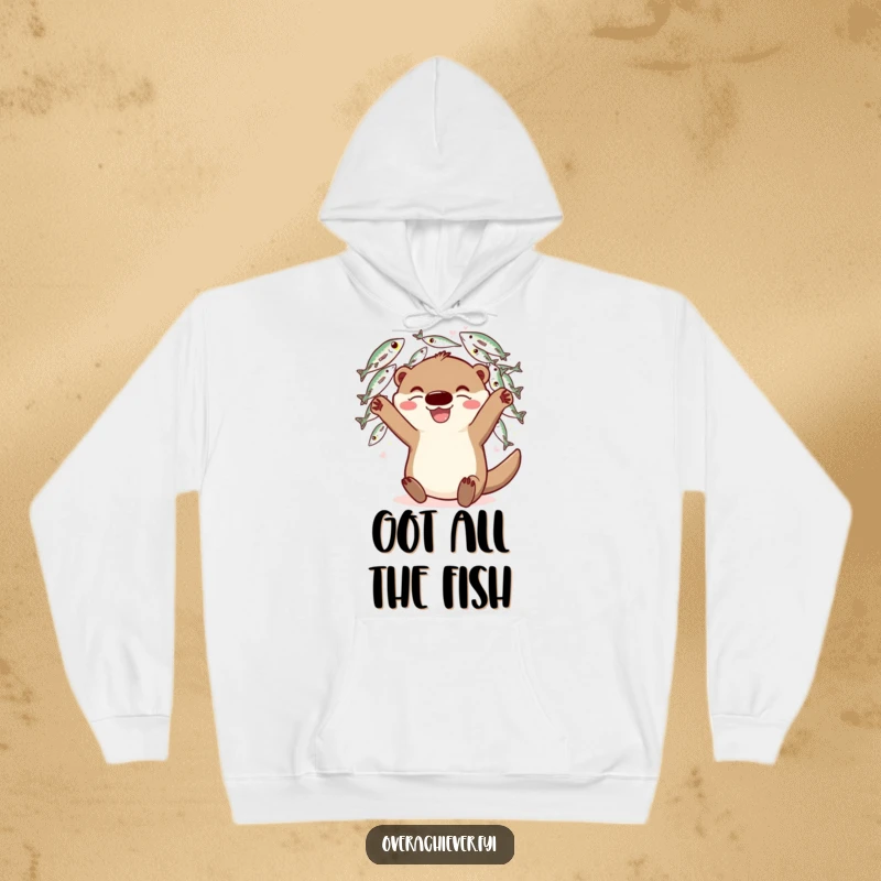 Funny Hoodie: A happy otter character juggling many fish with a grin, offering cozy comfort and humor.