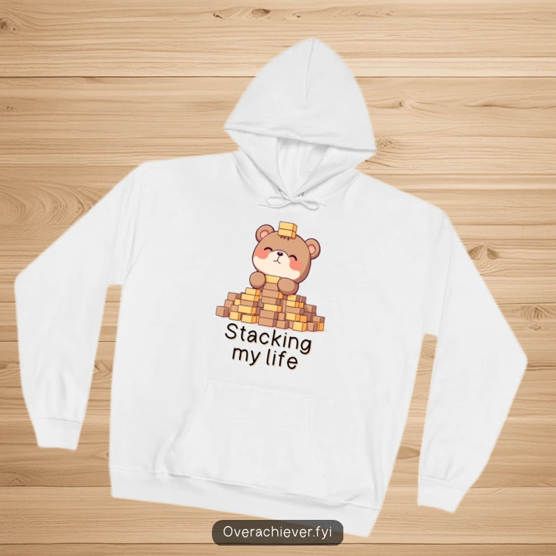 Funny hoodie featuring a focused bear gleefully stacking tiny blocks, providing warmth and humorous dedication.