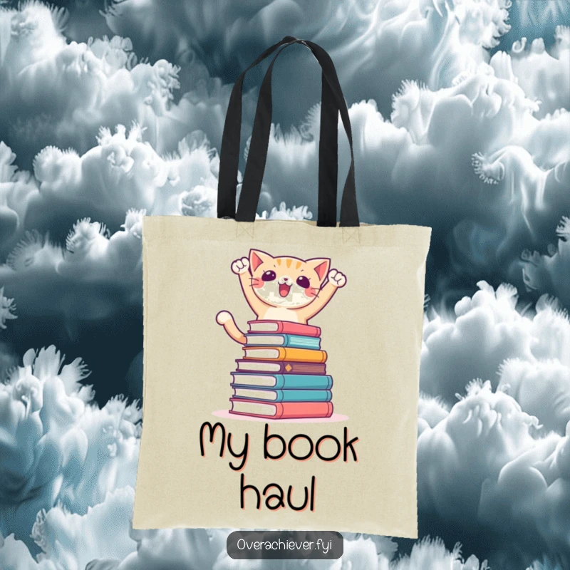 Funny tote bag featuring a triumphant cat character posing victoriously over a massive stack of books, perfect for book lovers.